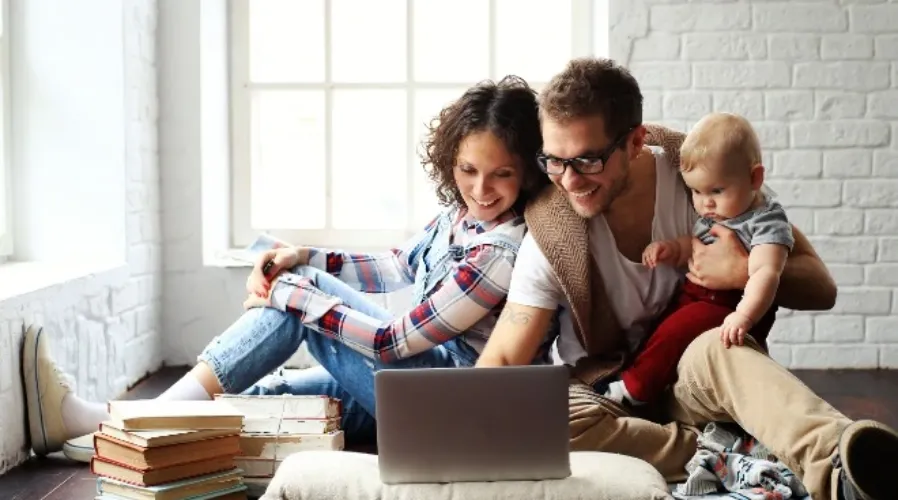 Mother, father and child using their laptop
