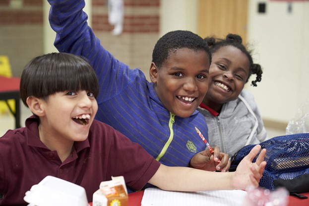 Three small Children Smiling at School